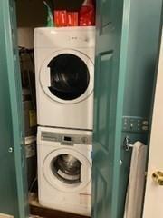 washroom featuring laundry area and stacked washer / drying machine