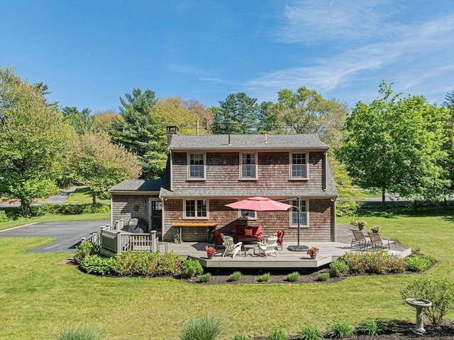 771 Ferry St, Marshfield, MA 02050 - back of house with a wooden deck, a chimney, and a lawn