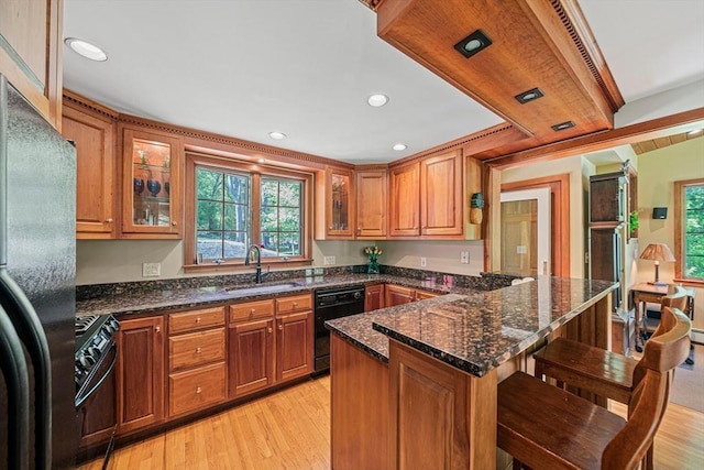 771 Ferry St, Marshfield, MA 02050 - kitchen with black appliances, a sink, brown cabinets, and recessed lighting