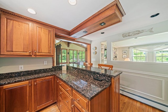 771 Ferry St, Marshfield, MA 02050 - kitchen featuring a baseboard heating unit, a peninsula, brown cabinets, light wood finished floors, and recessed lighting