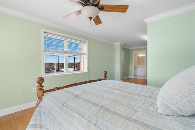 bedroom with ensuite bath, ceiling fan, crown molding, and light wood-type flooring