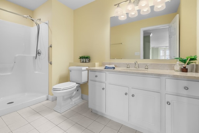 bathroom featuring toilet, vanity, tile patterned floors, and walk in shower