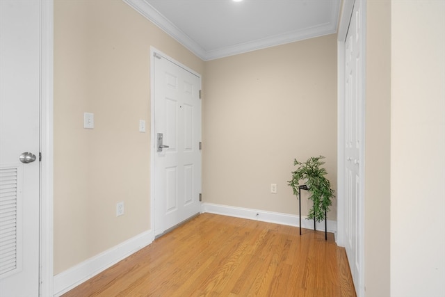 hallway featuring light hardwood / wood-style flooring and crown molding