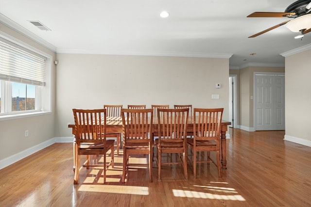 dining space with light hardwood / wood-style floors, ceiling fan, and crown molding