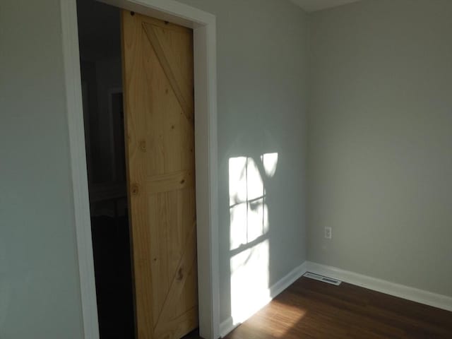 empty room with wood-type flooring