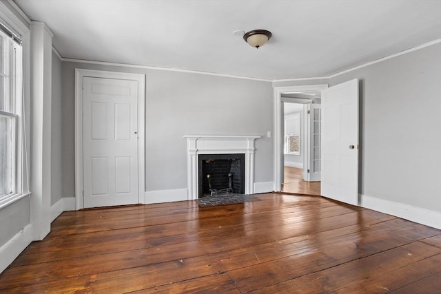 unfurnished living room with crown molding and dark hardwood / wood-style floors