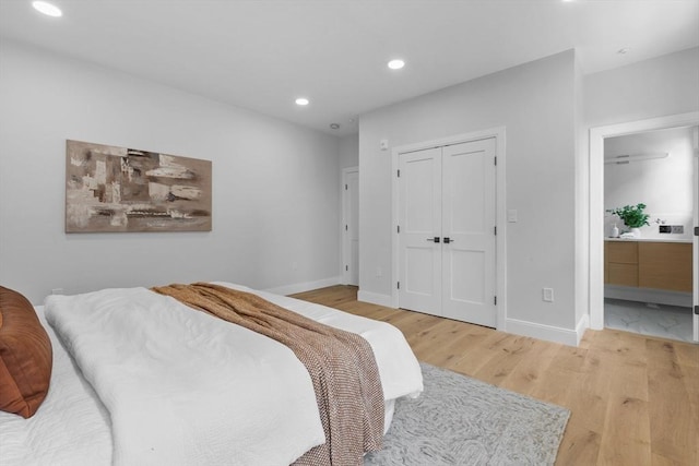 bedroom featuring light hardwood / wood-style flooring and a closet