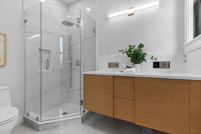 bathroom featuring toilet, vanity, and an enclosed shower