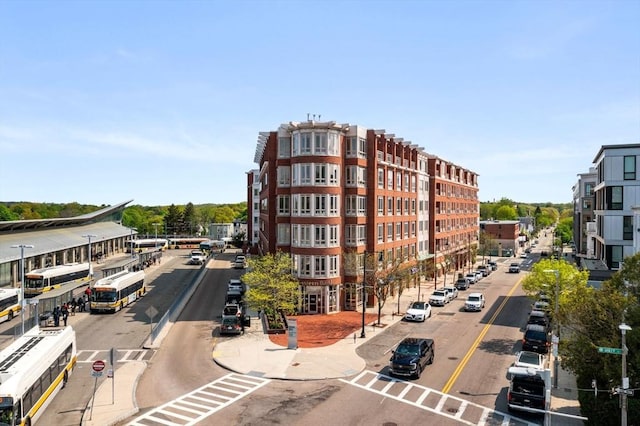 view of apartment building / complex featuring uncovered parking and central AC