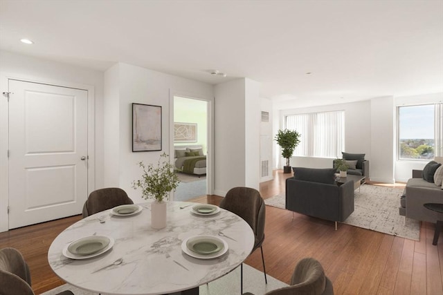 dining area with wood finished floors and recessed lighting