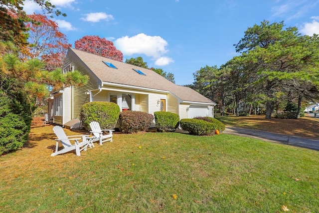 view of front of house with a garage and a front yard