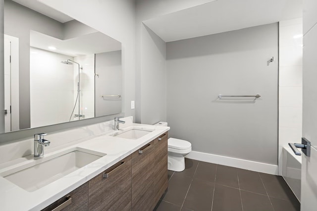 bathroom featuring toilet, vanity, and tile patterned floors