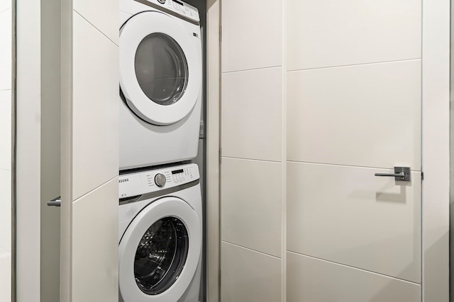 laundry area featuring stacked washer and dryer