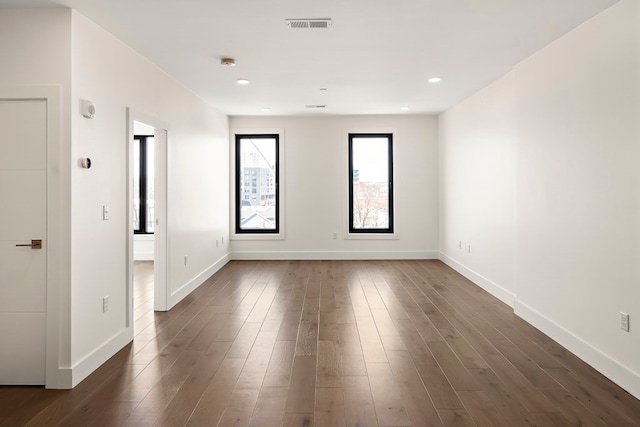 spare room with dark hardwood / wood-style flooring