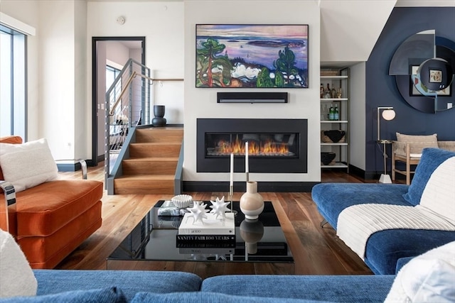 living room featuring wood-type flooring and built in features