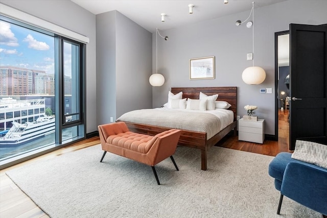 bedroom featuring hardwood / wood-style floors and access to exterior