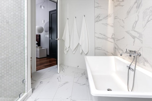 bathroom featuring wood-type flooring and separate shower and tub