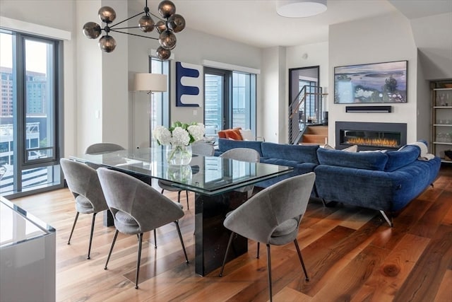 dining area featuring hardwood / wood-style flooring and an inviting chandelier