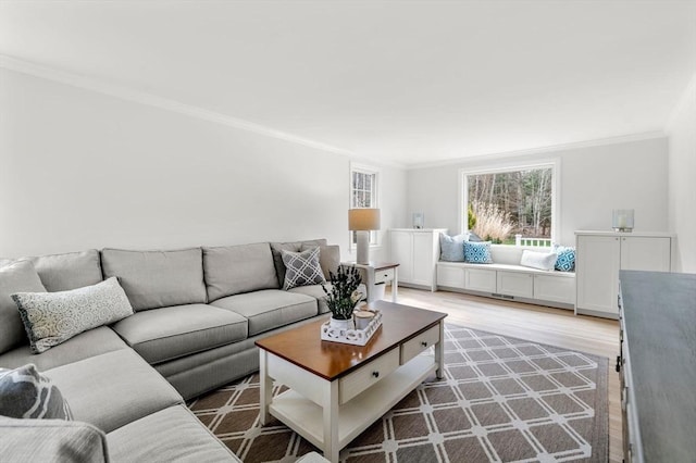 living room with ornamental molding and light wood-type flooring