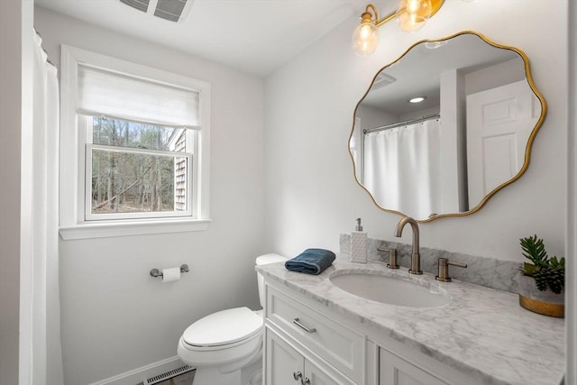 full bathroom with vanity, baseboards, toilet, and visible vents