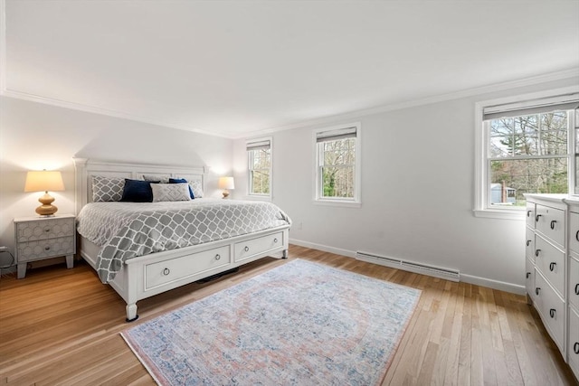 bedroom with ornamental molding, baseboard heating, and multiple windows