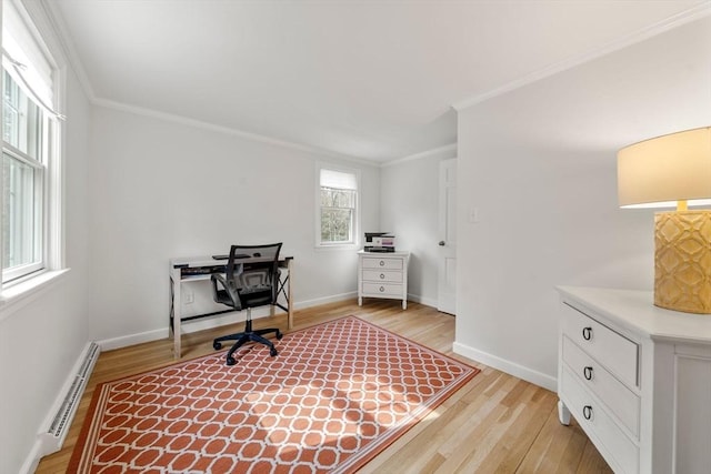 office space with crown molding, baseboards, baseboard heating, and light wood-style flooring