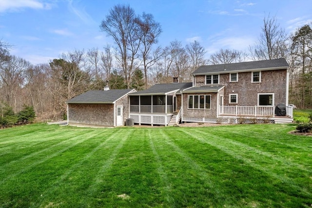 back of house with a yard, a deck, cooling unit, and a sunroom