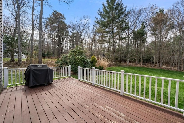 wooden deck with a yard and grilling area
