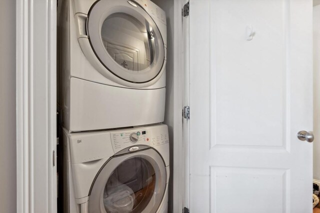 clothes washing area with laundry area and stacked washer / dryer