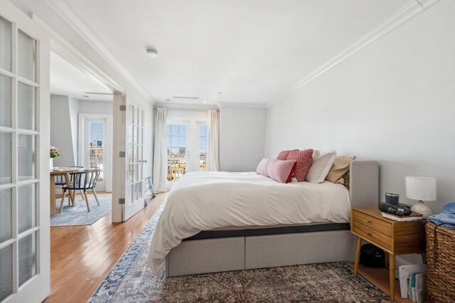 bedroom featuring ornamental molding, french doors, and wood finished floors