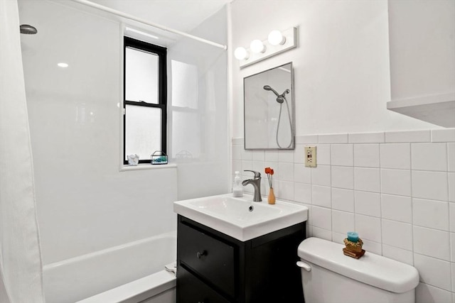 full bathroom featuring vanity, bathtub / shower combination, tile walls, and toilet