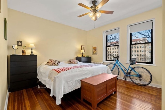 bedroom with dark hardwood / wood-style floors and ceiling fan