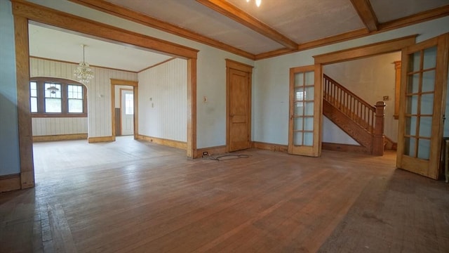 31 Burton St, Springfield, MA 01108 - unfurnished living room with french doors, wood finished floors, a chandelier, baseboards, and beamed ceiling