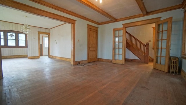 31 Burton St, Springfield, MA 01108 - unfurnished living room with wood finished floors, a chandelier, french doors, crown molding, and radiator