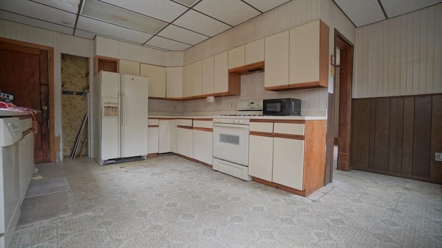 31 Burton St, Springfield, MA 01108 - kitchen with white appliances, a drop ceiling, light countertops, light flooring, and wooden walls