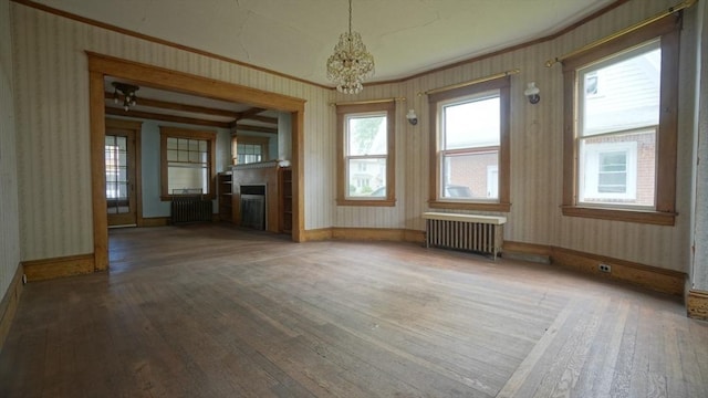 31 Burton St, Springfield, MA 01108 - unfurnished living room featuring radiator heating unit, hardwood / wood-style floors, wallpapered walls, a chandelier, and a fireplace