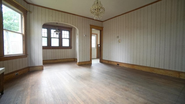 31 Burton St, Springfield, MA 01108 - unfurnished room featuring ornamental molding, hardwood / wood-style flooring, wallpapered walls, baseboards, and arched walkways
