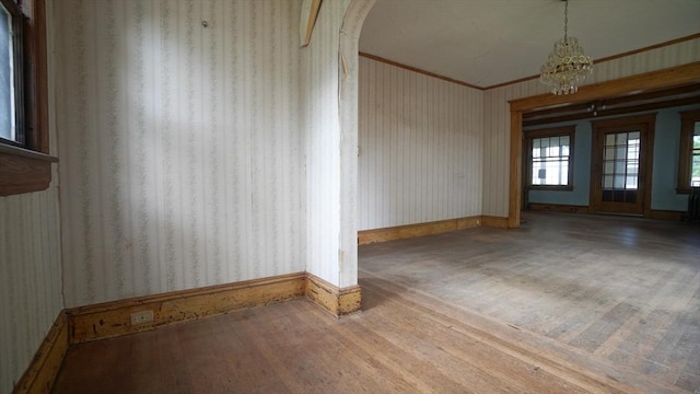 31 Burton St, Springfield, MA 01108 - unfurnished room with wallpapered walls, crown molding, baseboards, wood finished floors, and arched walkways
