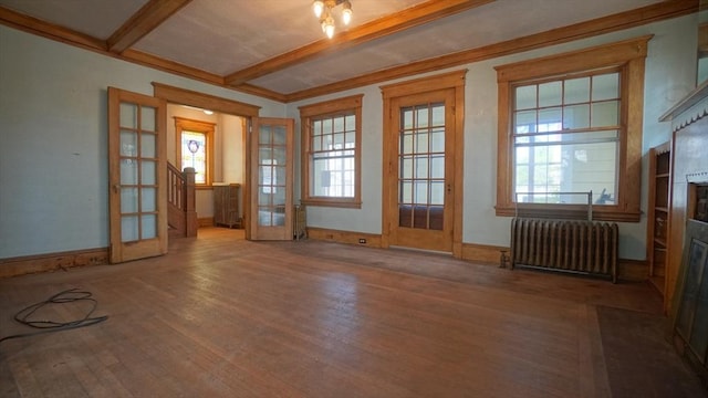 31 Burton St, Springfield, MA 01108 - spare room featuring radiator, wood finished floors, beamed ceiling, baseboards, and french doors
