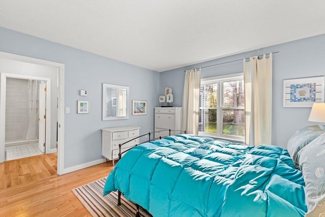 bedroom featuring light wood-type flooring and baseboards