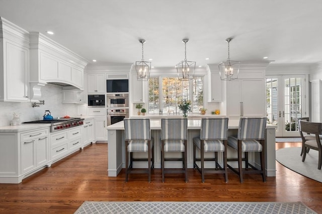 kitchen with a center island, white cabinets, and light countertops