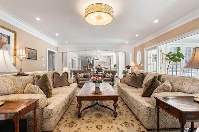 living room with decorative columns, ornamental molding, a chandelier, and recessed lighting