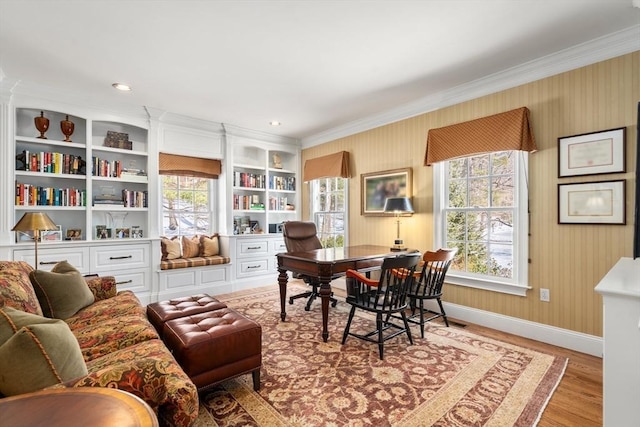 living area with baseboards, a healthy amount of sunlight, light wood finished floors, and wallpapered walls