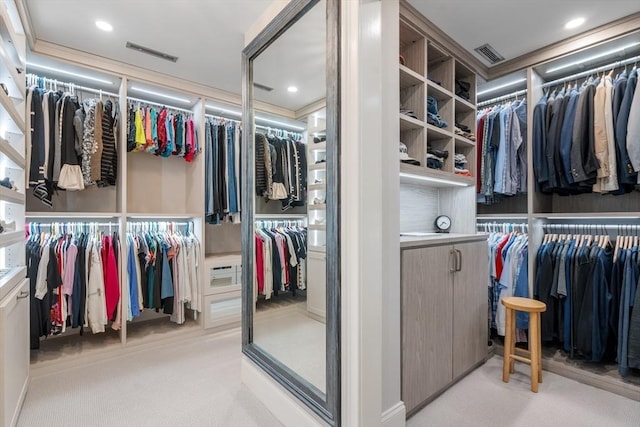 walk in closet featuring light carpet and visible vents