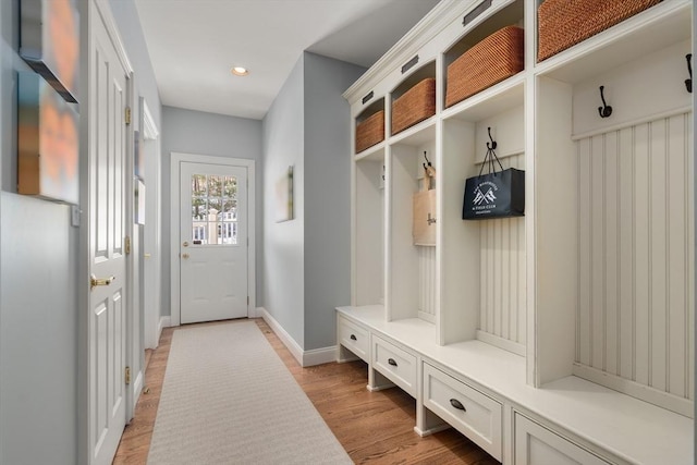 mudroom with light wood finished floors, recessed lighting, and baseboards