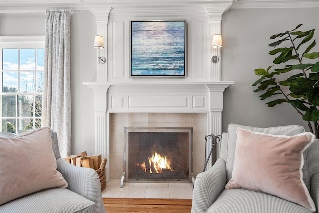 living area featuring a fireplace and crown molding