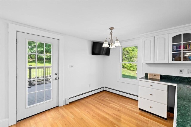 67 Greenfield Ln, Scituate, MA 02066 - unfurnished dining area with a chandelier, healthy amount of natural light, light wood-style floors, and baseboard heating