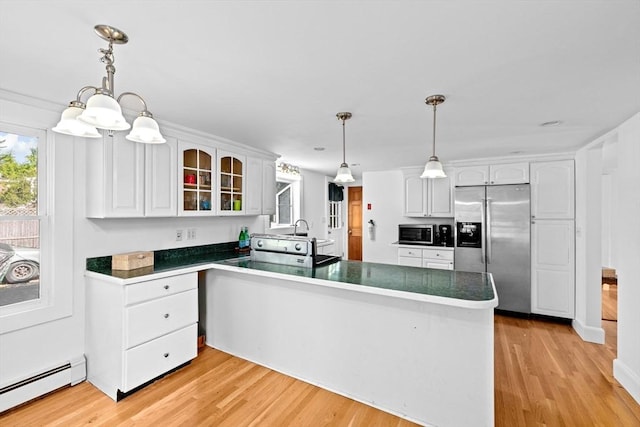 67 Greenfield Ln, Scituate, MA 02066 - kitchen featuring stainless steel appliances, a baseboard radiator, a peninsula, glass insert cabinets, and white cabinets