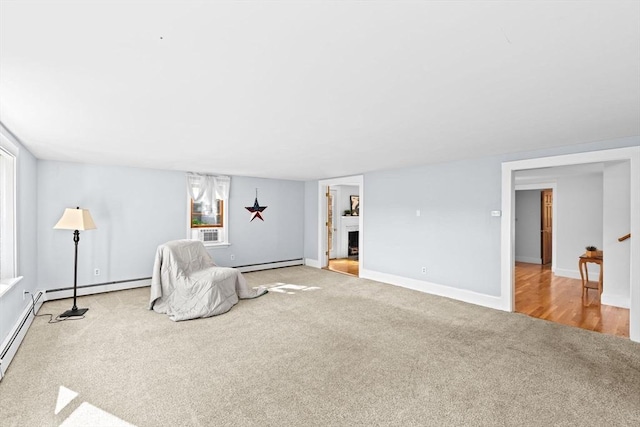 67 Greenfield Ln, Scituate, MA 02066 - unfurnished room with carpet, a baseboard heating unit, a fireplace with raised hearth, and baseboards