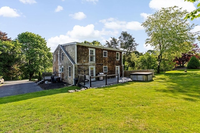 67 Greenfield Ln, Scituate, MA 02066 - rear view of property featuring a hot tub, a yard, and a wooden deck